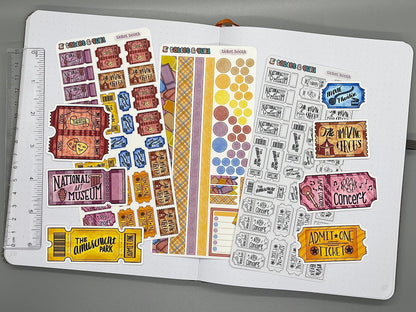 An overview image of tickets themed stickers, including a color sticker sheet, a colorable sticker sheet, a decorative sticker sheet, and die cut sticker flakes. Ruler on the left. 