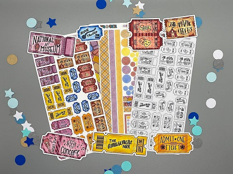 An overview image of tickets themed stickers, including a color sticker sheet, a colorable sticker sheet, a decorative sticker sheet, and die cut sticker flakes.