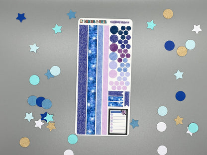 Sticker sheet with matching design as our planet themed stickers on a gray background with decorative stars and circles.