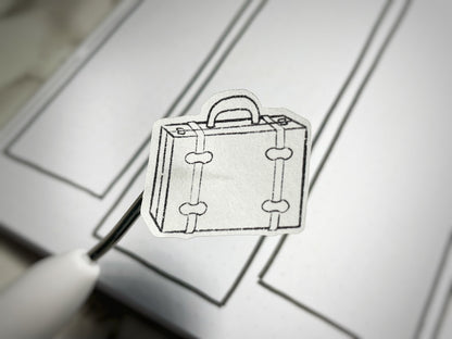Closeup of a vintage luggage colorable sticker for bullet journals. 