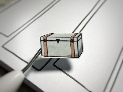 Closeup of an in color vintage luggage sticker for bullet journals and planners. 