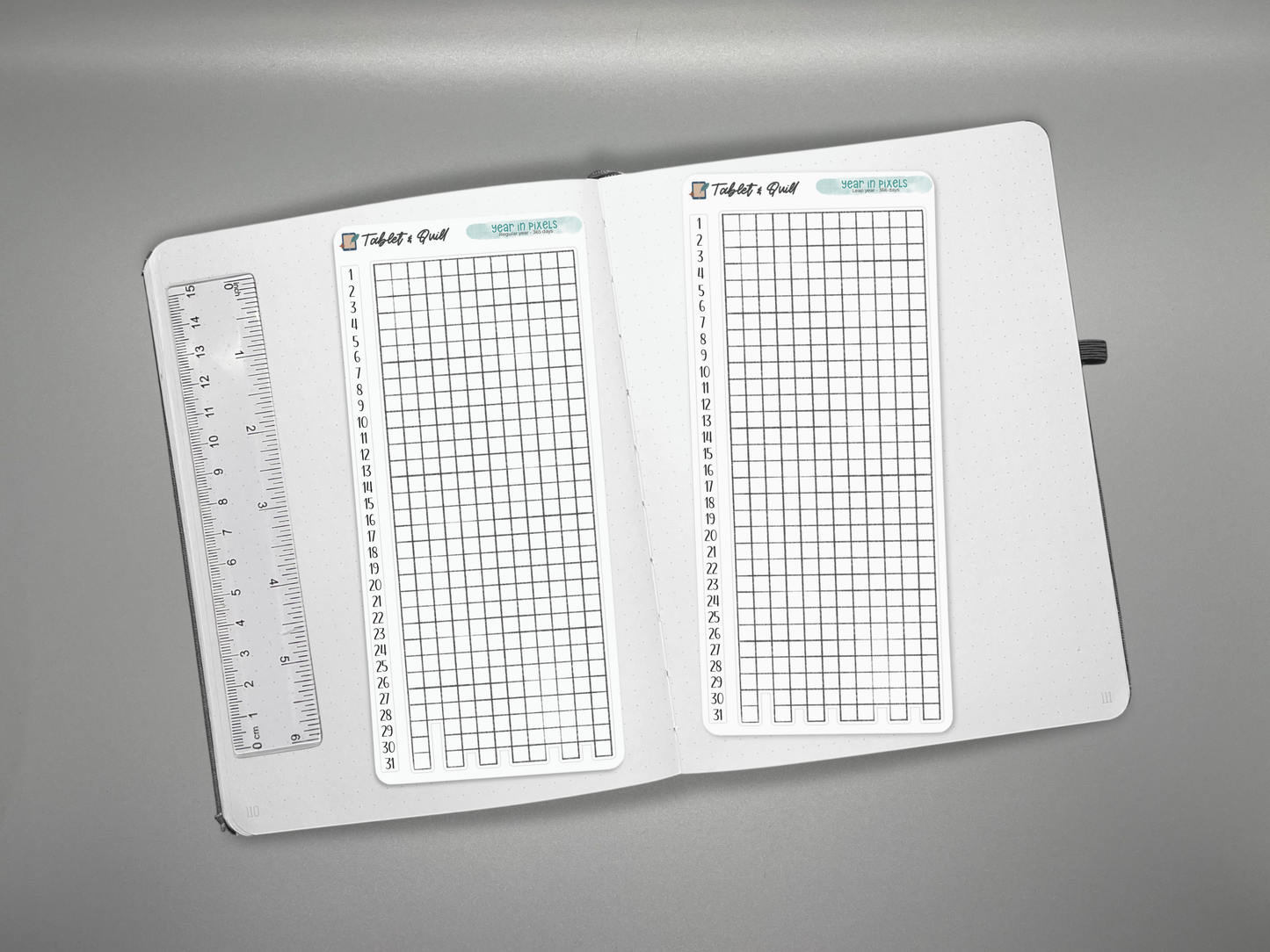 Two year in pixels with matching number strip sticker sheets on a journal with a ruler for scale.